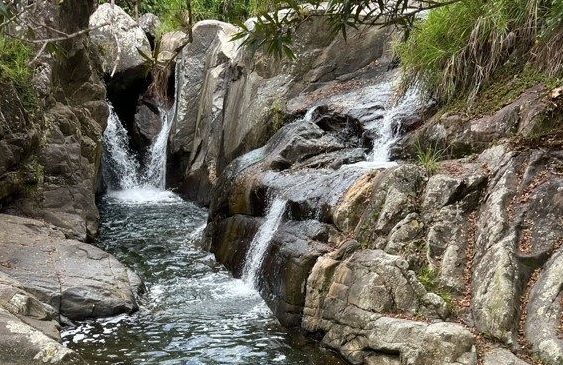 a large waterfall over a rocky cliff