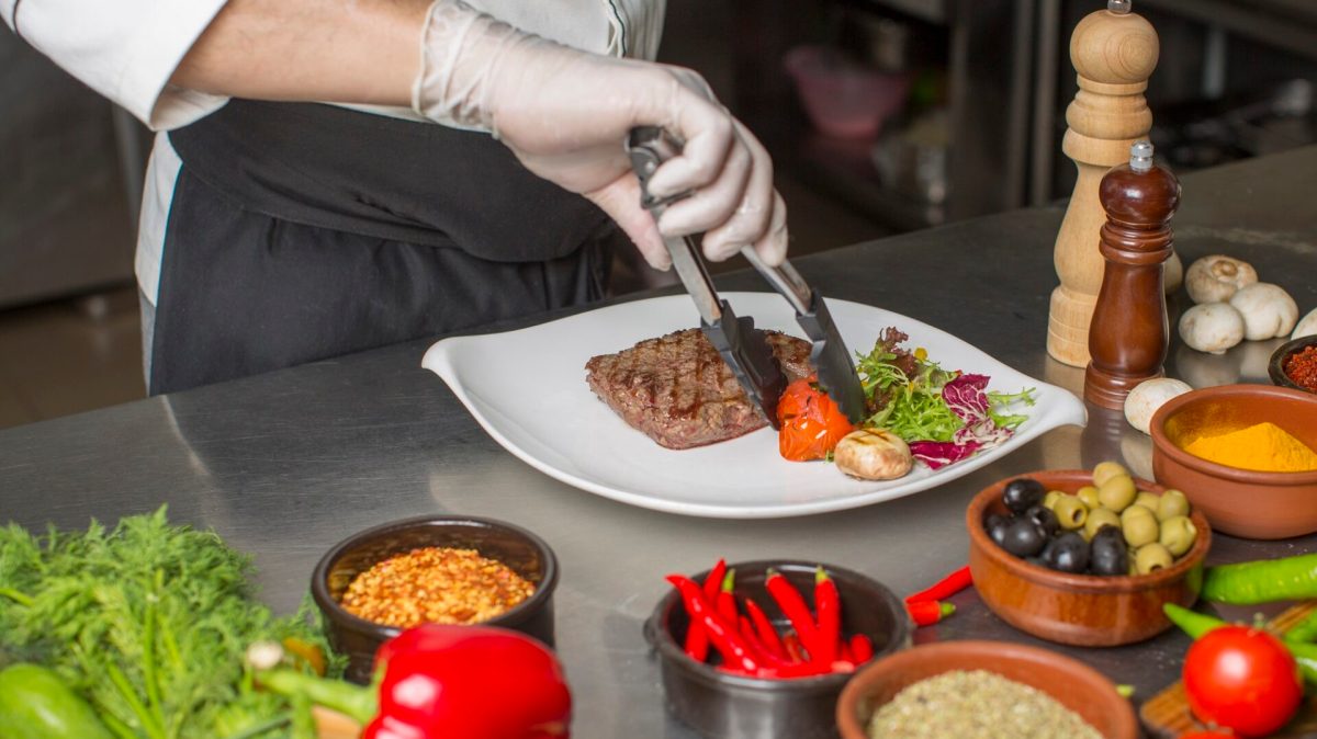 a person sitting at a table with a plate of food