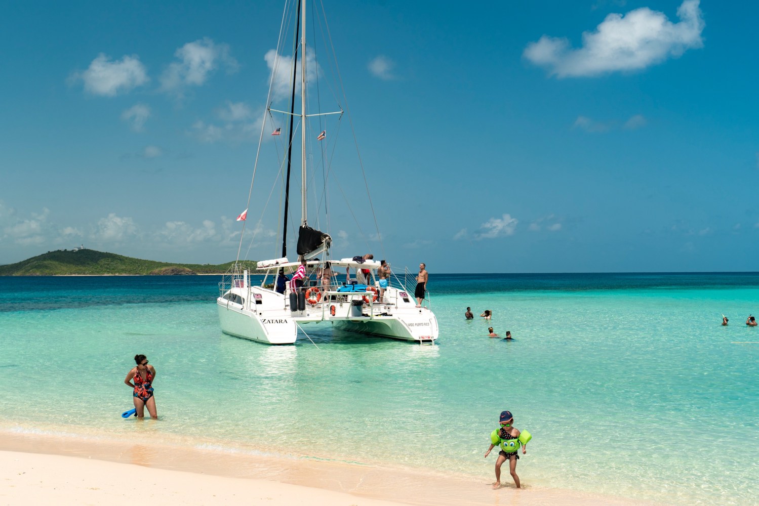 a boat floating on top of a sandy beach
